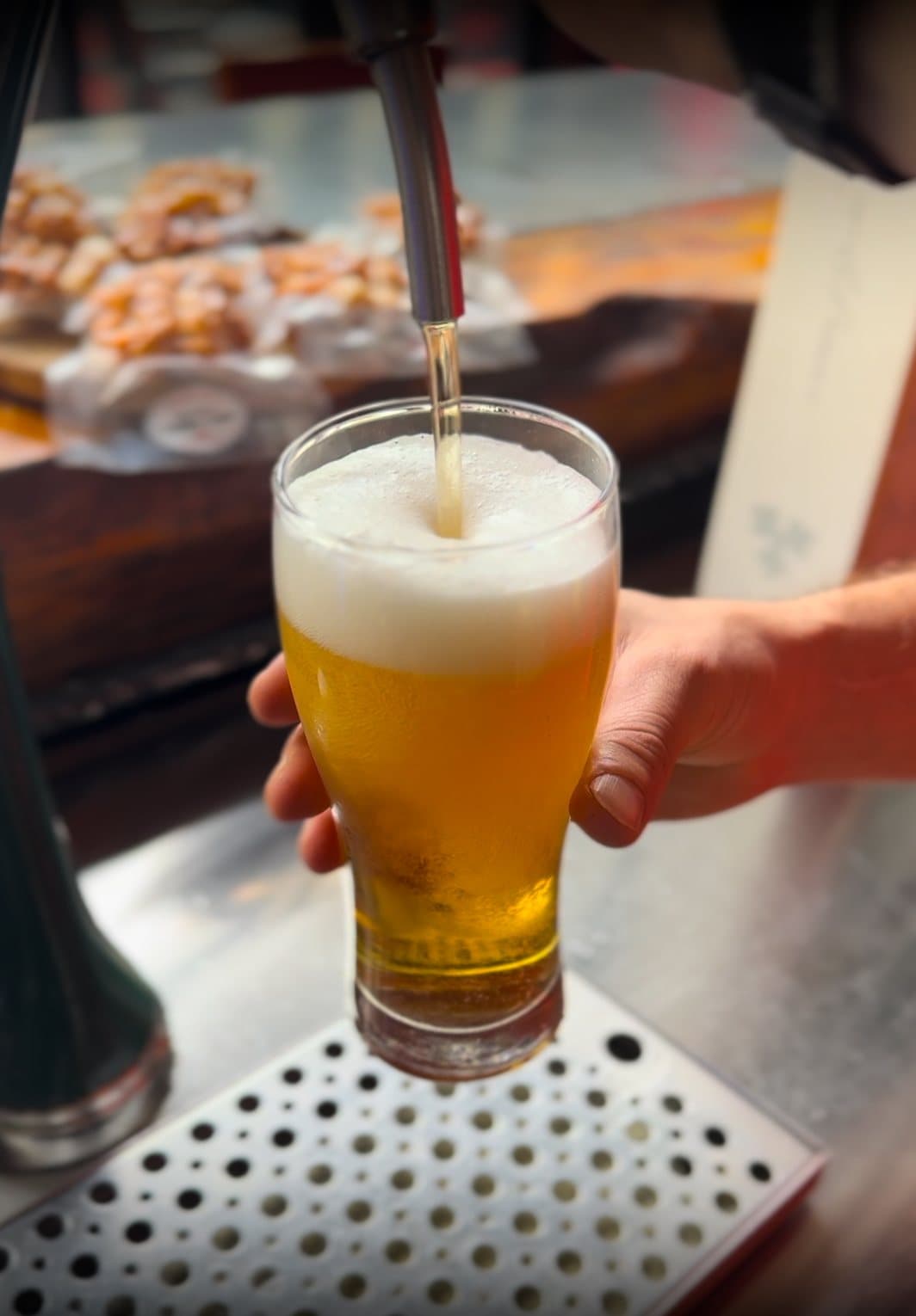 A cold beer being pulled at the bar at Dirty Fingers