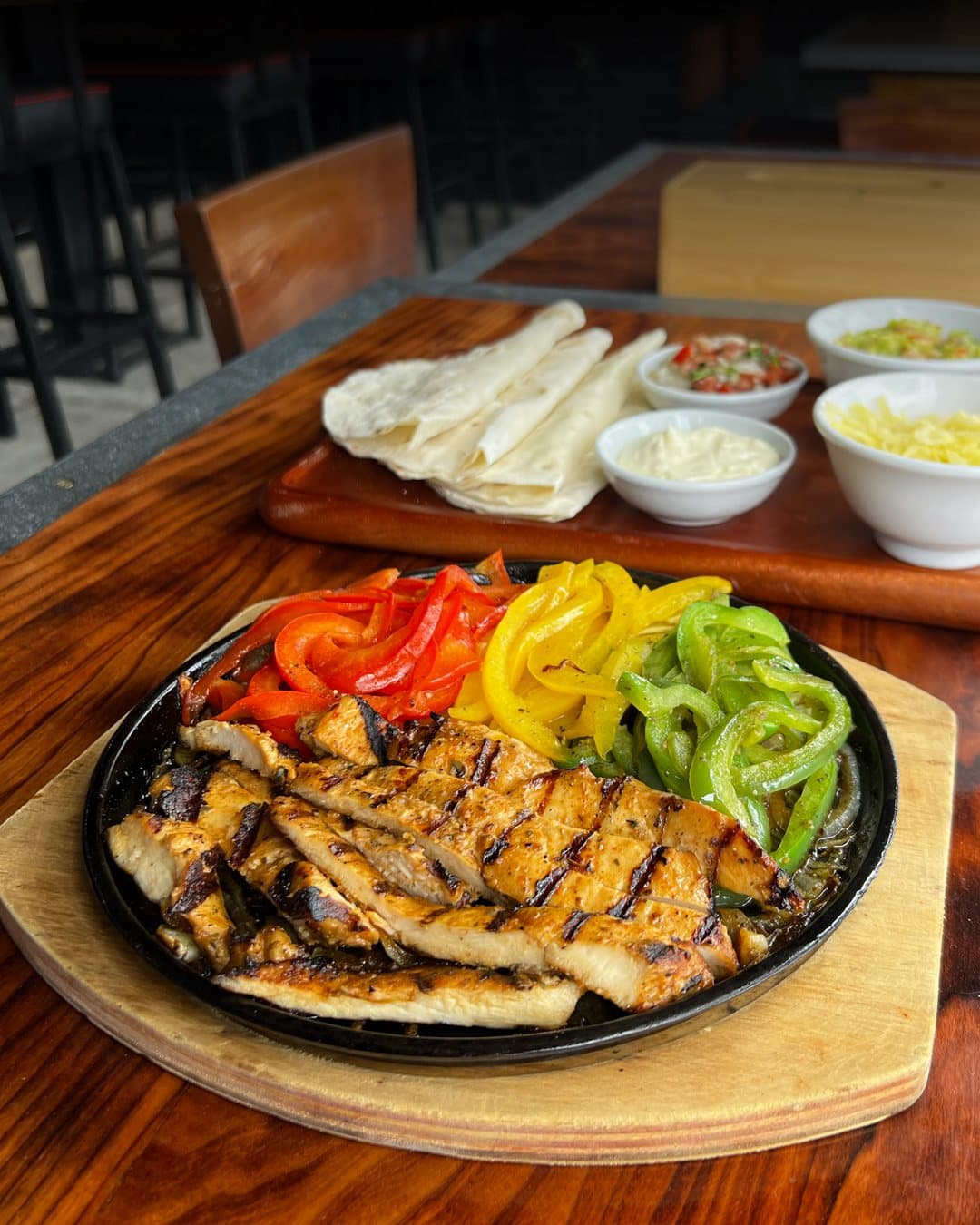 Chicken fajitas served on a hot metal pan at Dirty Fingers.